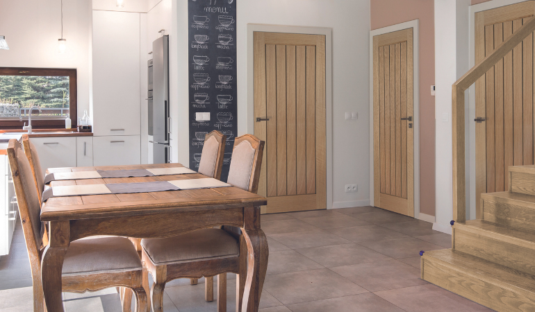 A contemporary Oak Belize fire door which has 5 slim oak vertical panels 