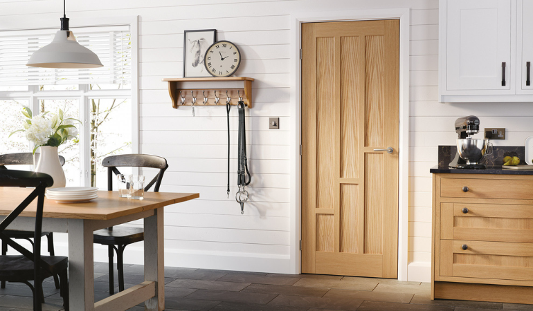 Oak Coventry Fire Door which is an internal door with a rustic oak finish and 3 graduating panels which go up in steps